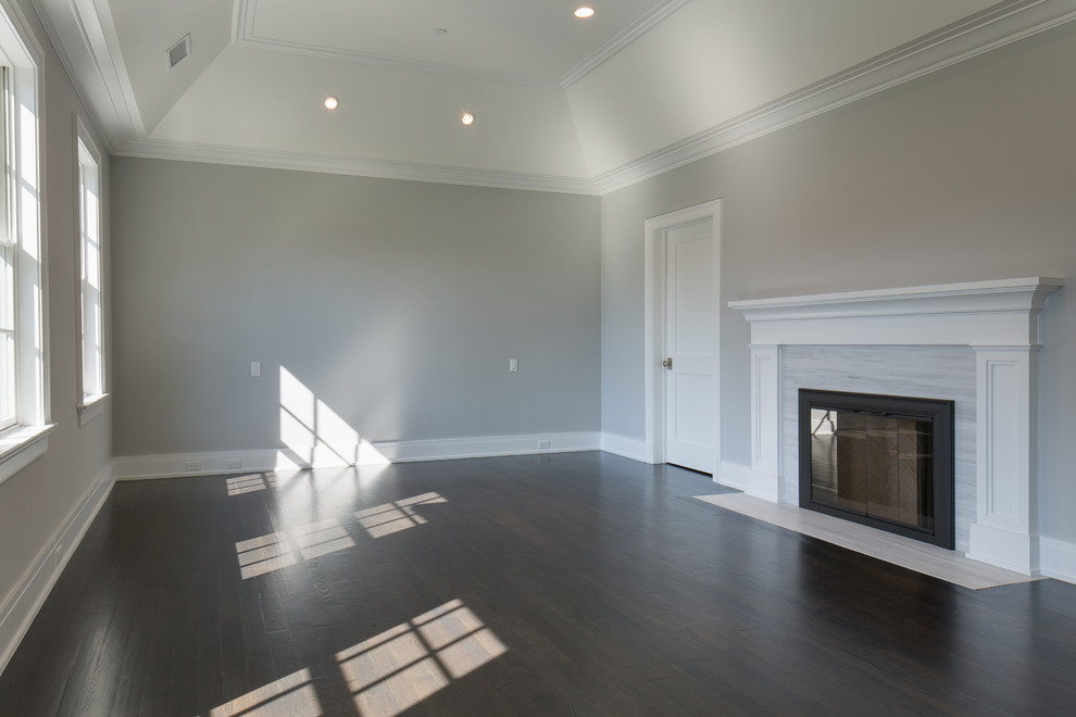 Family room - large transitional enclosed dark wood floor family room idea in New York with gray walls, a standard fireplace and a tile fireplace