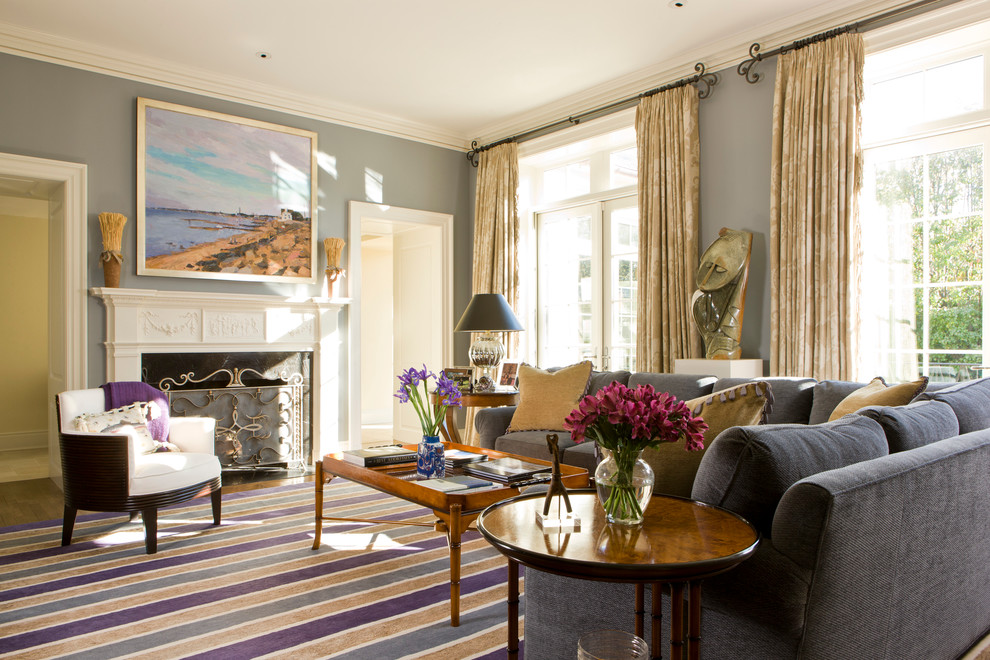 Inspiration for a timeless enclosed medium tone wood floor family room remodel in DC Metro with a standard fireplace, a stone fireplace, blue walls and no tv
