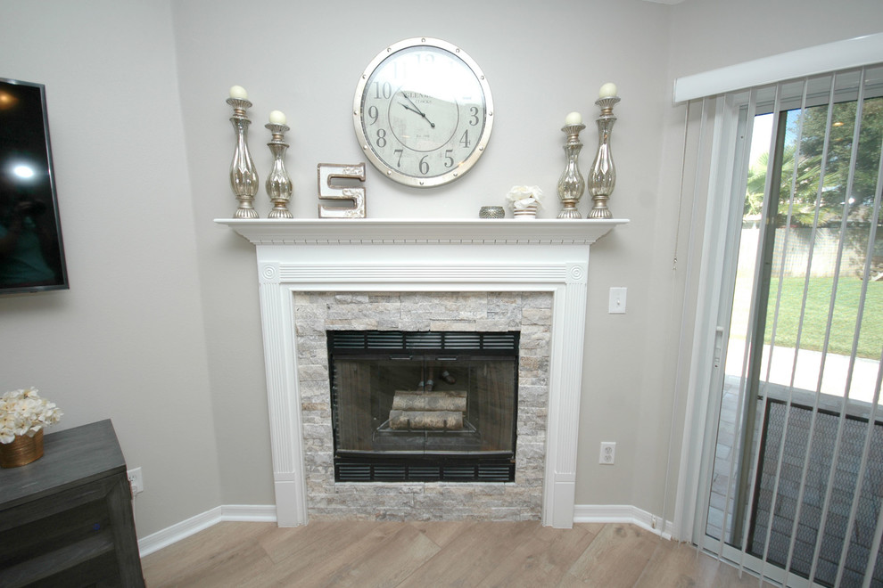 Example of a mid-sized trendy open concept family room design in Jacksonville with a standard fireplace and a wood fireplace surround