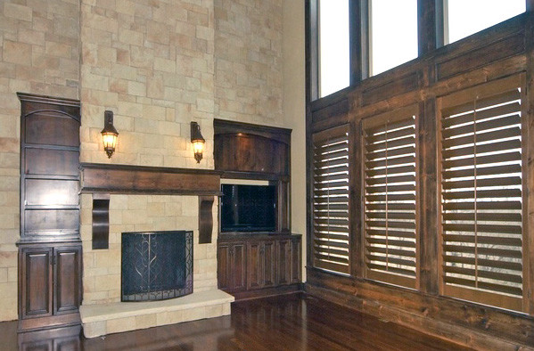 Traditional games room in Toronto with a standard fireplace, a stone fireplace surround and no tv.