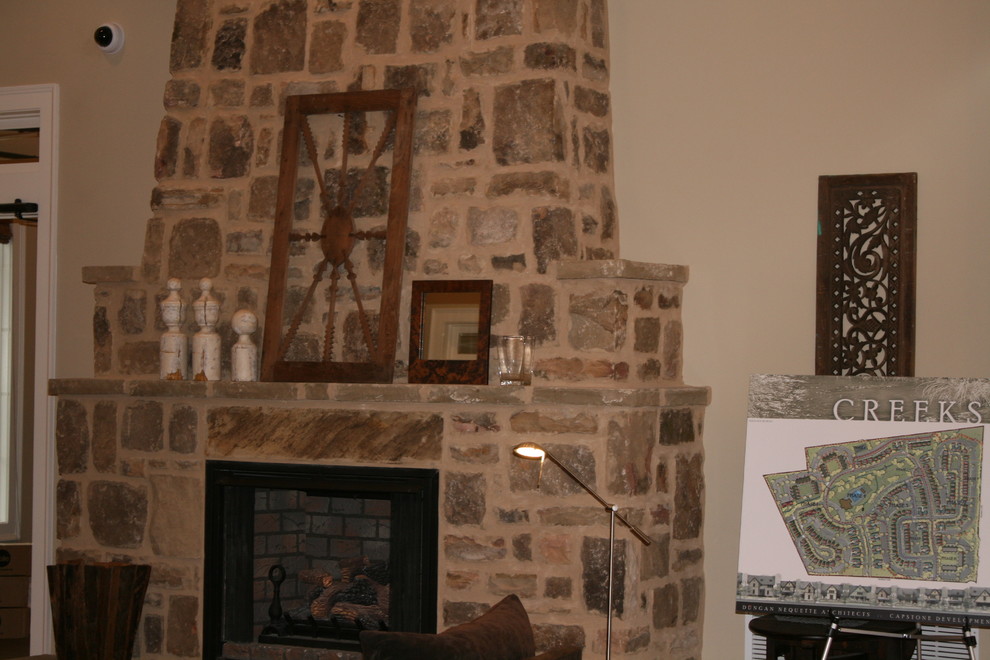 Mittelgroßes, Fernseherloses Rustikales Wohnzimmer im Loft-Stil mit beiger Wandfarbe, Kamin und Kaminumrandung aus Stein in Atlanta