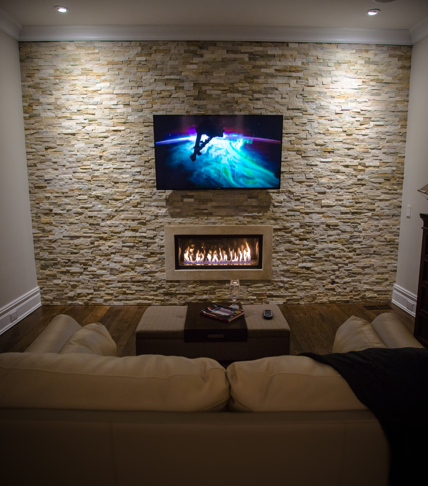 Foto de sala de estar cerrada tradicional renovada de tamaño medio con paredes beige, suelo de madera oscura, televisor colgado en la pared, chimenea lineal y marco de chimenea de piedra