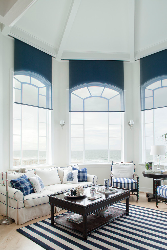 Family room - contemporary light wood floor family room idea in Los Angeles with white walls