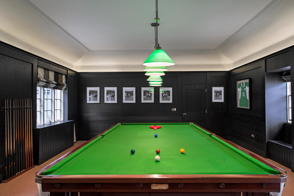 Medium sized farmhouse open plan games room in Dublin with black walls, carpet, a corner fireplace, a metal fireplace surround and a built-in media unit.