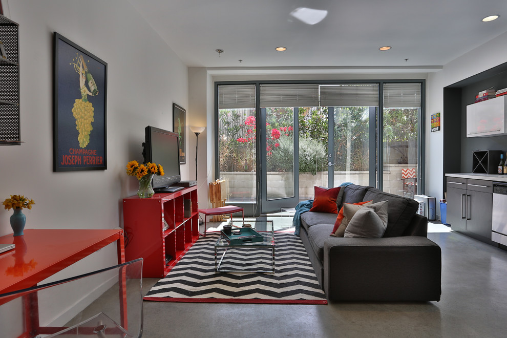 Example of a small urban open concept concrete floor family room design in San Luis Obispo with white walls and a tv stand
