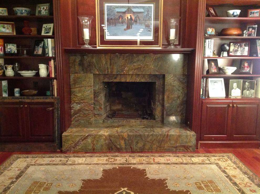 Photo of a medium sized classic enclosed games room in DC Metro with a reading nook, medium hardwood flooring, a standard fireplace, a stone fireplace surround and no tv.