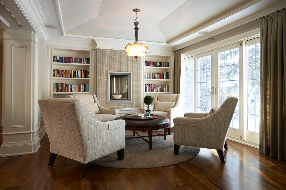 Inspiration for a large traditional open plan games room in Toronto with a reading nook, beige walls, dark hardwood flooring, a tiled fireplace surround, no tv and a ribbon fireplace.