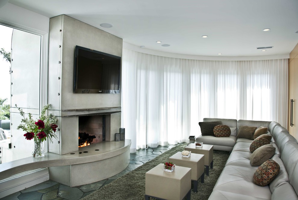 Family room - large coastal enclosed slate floor family room idea in San Diego with a bar, white walls, a two-sided fireplace, a concrete fireplace and a wall-mounted tv