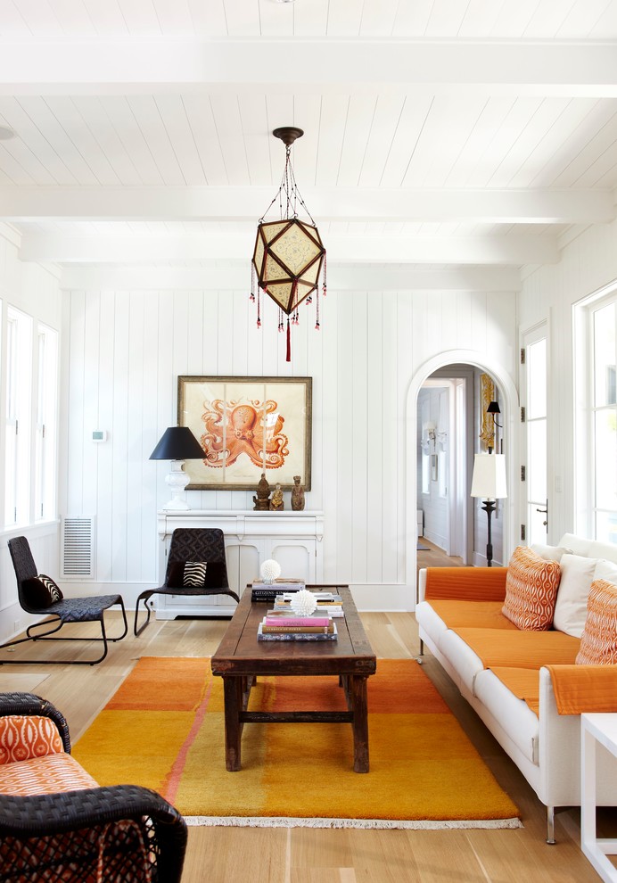 Abgetrenntes Maritimes Wohnzimmer mit weißer Wandfarbe und hellem Holzboden in Charleston