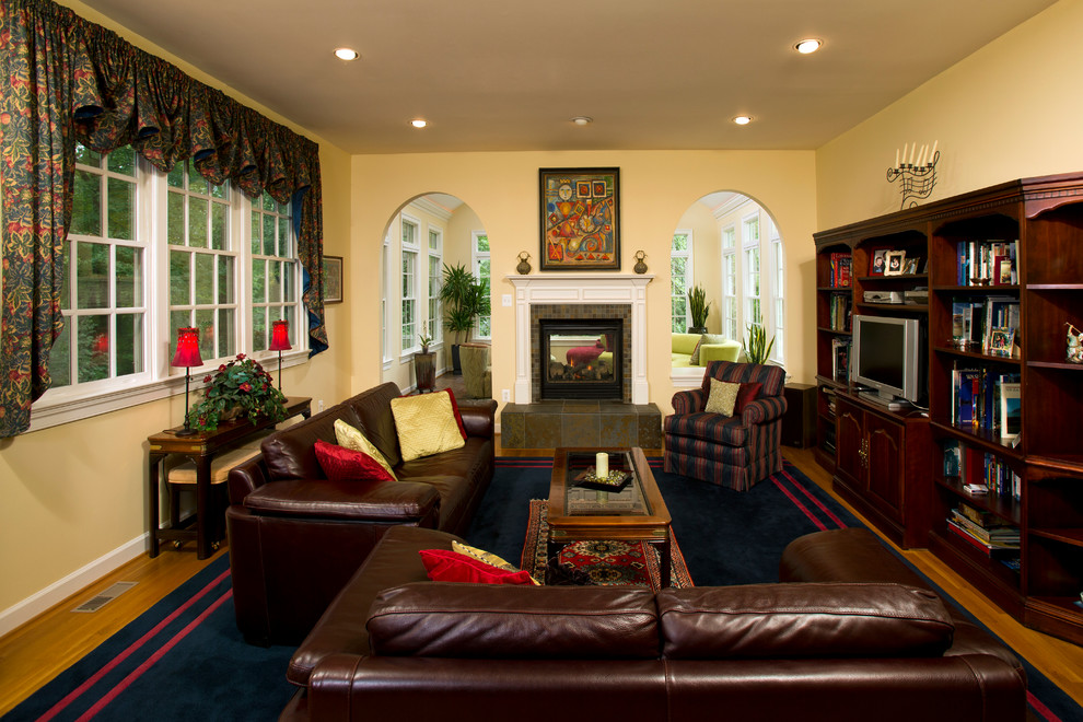 Medium sized traditional open plan games room in DC Metro with beige walls, ceramic flooring, a two-sided fireplace and a brick fireplace surround.