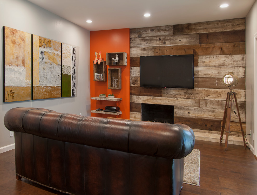 Family room - mid-sized eclectic dark wood floor family room idea in San Francisco with orange walls and a wall-mounted tv