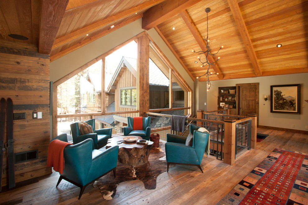 Trendy loft-style medium tone wood floor family room photo in Portland with beige walls