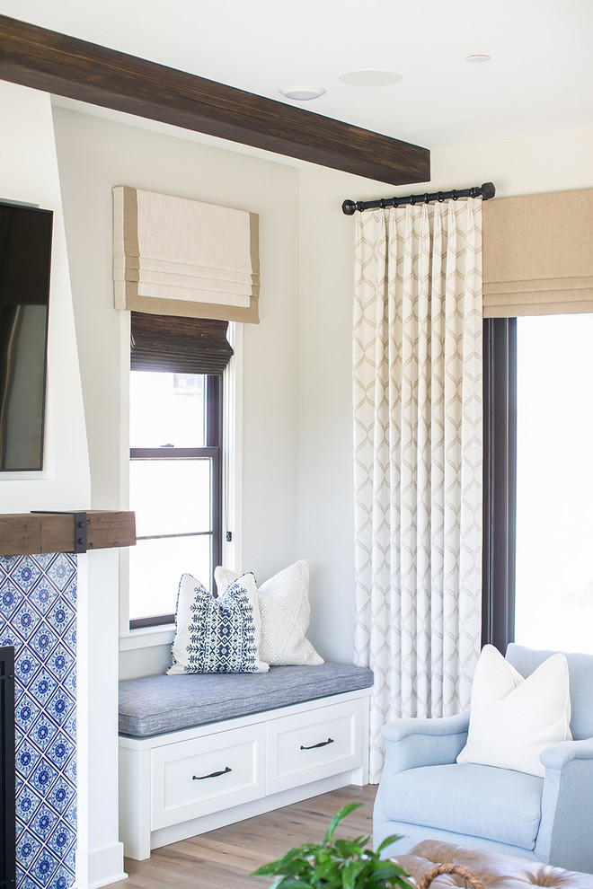 Maritimes Wohnzimmer mit grauer Wandfarbe, braunem Holzboden, Kamin, gefliester Kaminumrandung und TV-Wand in San Diego