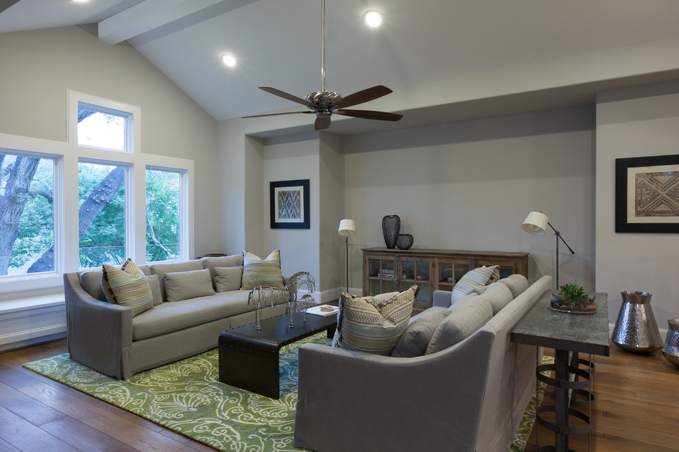 Family room - huge transitional enclosed light wood floor and brown floor family room idea in Houston with gray walls