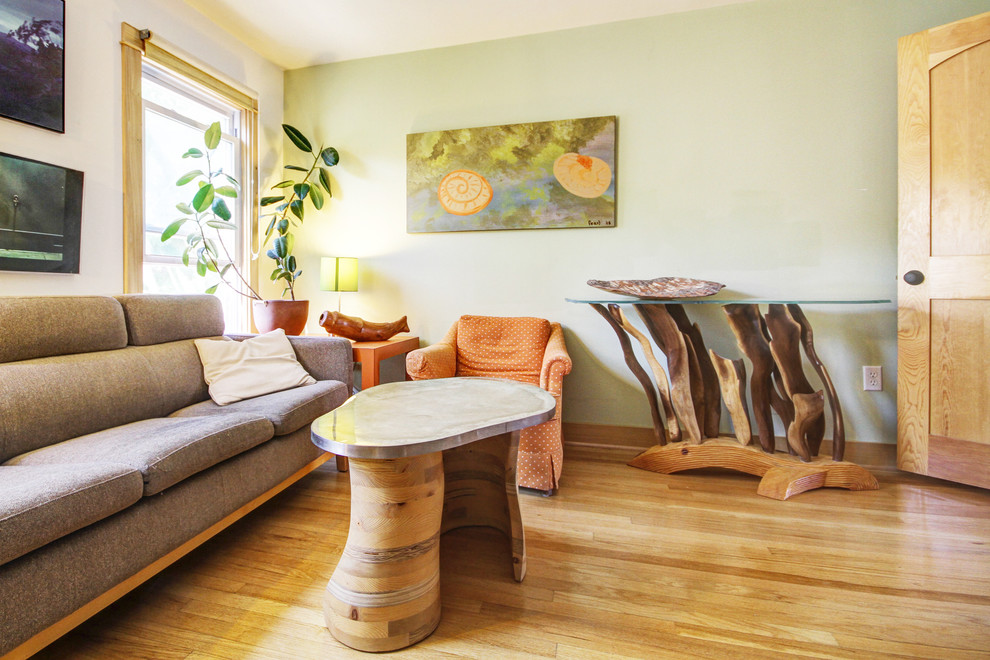 Inspiration for an eclectic medium tone wood floor family room remodel in Chicago with green walls