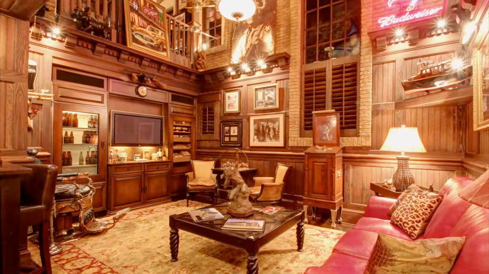Example of a large island style open concept dark wood floor game room design in Tampa with brown walls and a media wall