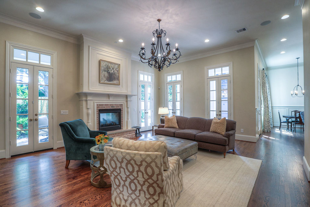 Design ideas for a large traditional enclosed games room in Houston with beige walls, dark hardwood flooring, a standard fireplace, a brick fireplace surround and a wall mounted tv.