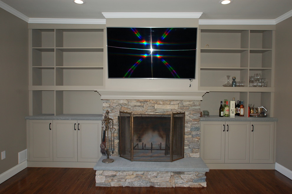 This is an example of a classic games room in New York with a standard fireplace and a stone fireplace surround.