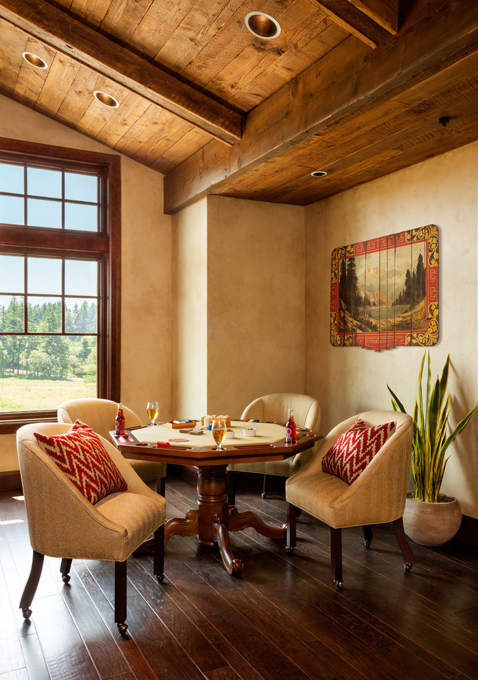 Example of a huge mountain style enclosed dark wood floor game room design in Portland with beige walls