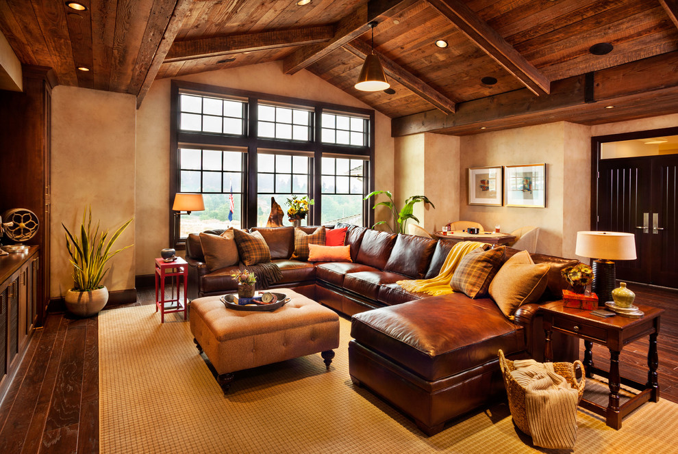 Inspiration for a huge rustic enclosed dark wood floor family room remodel in Portland with beige walls