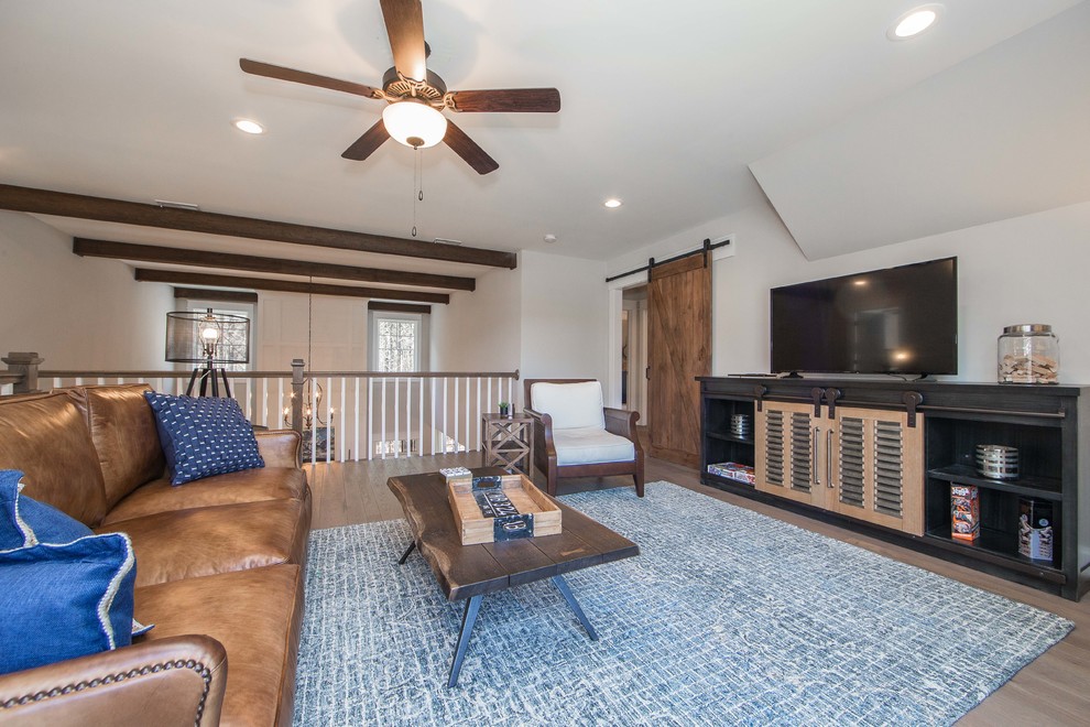 Foto de sala de estar tipo loft de estilo americano grande con paredes beige, suelo de madera en tonos medios, televisor independiente y suelo marrón