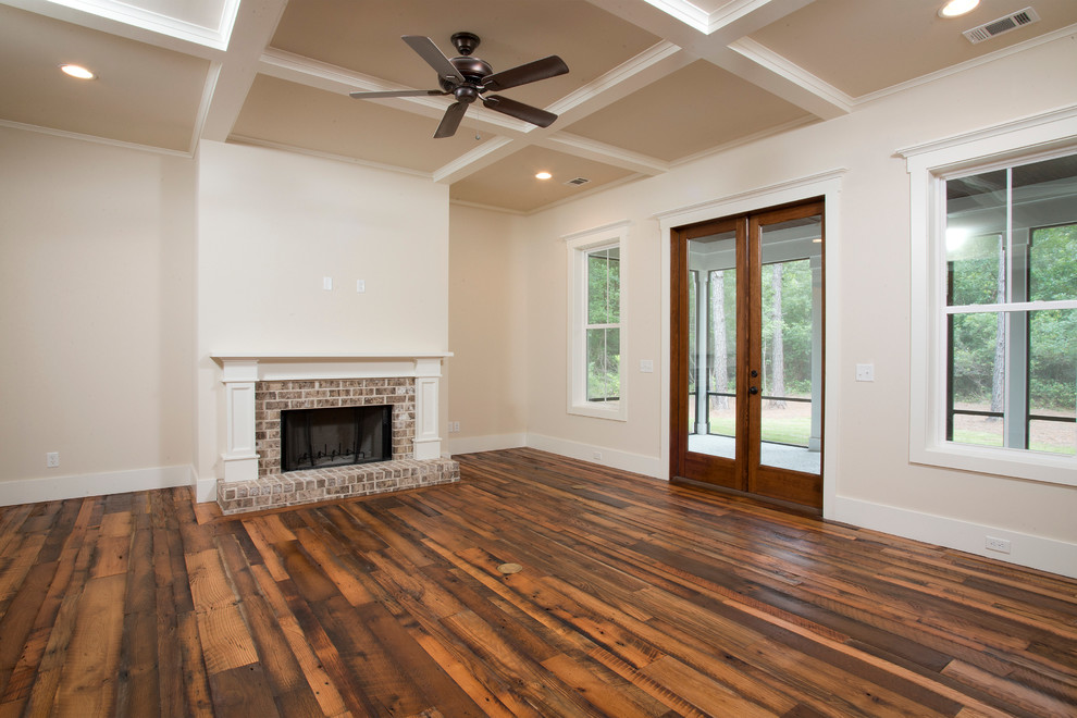 Mid-sized elegant medium tone wood floor family room photo in Charleston with beige walls, a standard fireplace and a brick fireplace