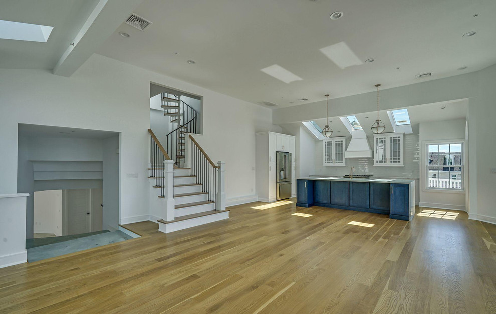 Inspiration for a huge coastal light wood floor and brown floor family room remodel in Newark with white walls