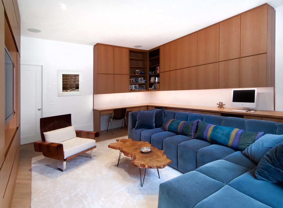 Example of a trendy enclosed medium tone wood floor family room design in New York with white walls