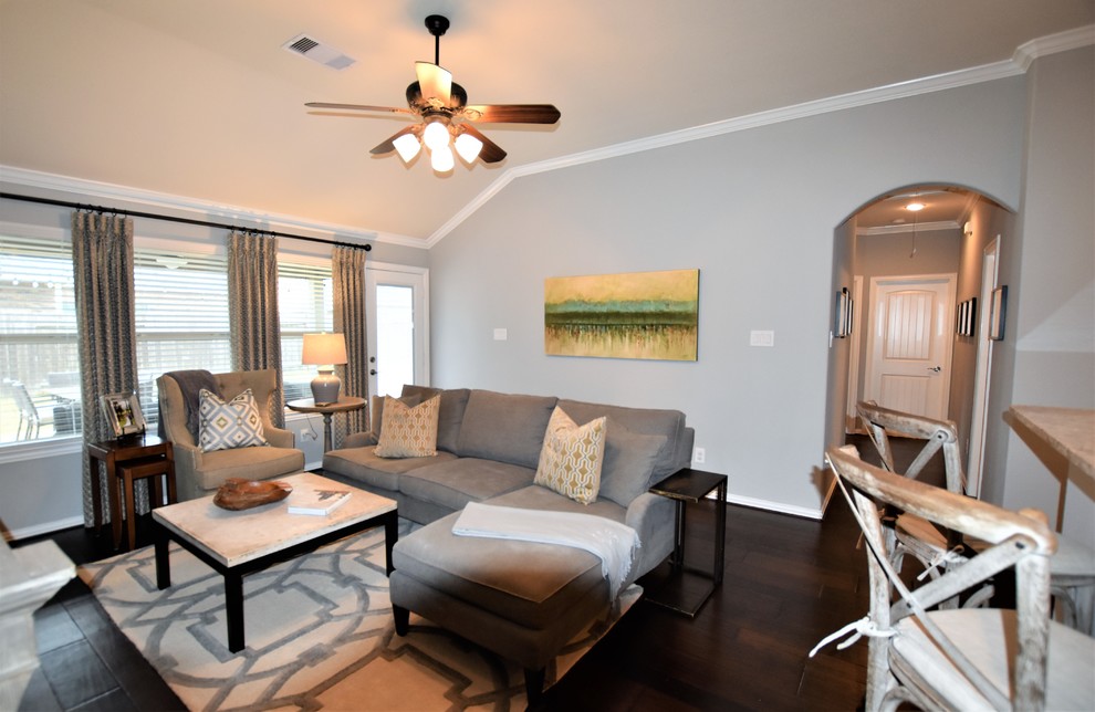 Photo of a medium sized classic mezzanine games room in Houston with grey walls, dark hardwood flooring, a freestanding tv and brown floors.