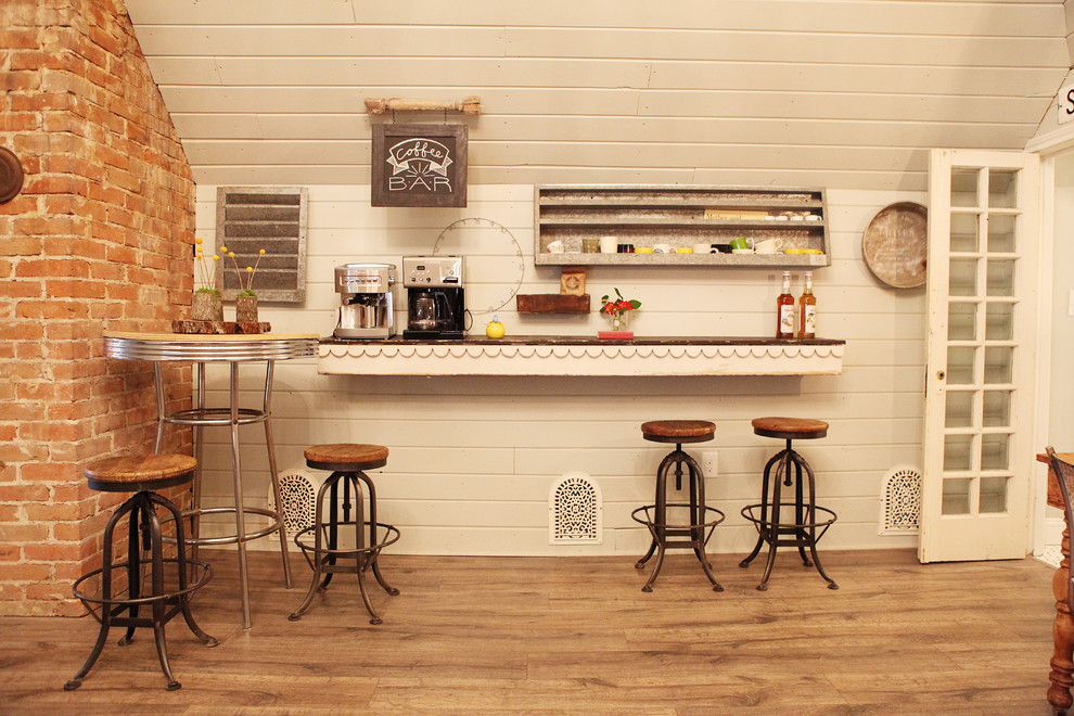 Inspiration for a mid-sized cottage medium tone wood floor family room remodel in Austin with white walls