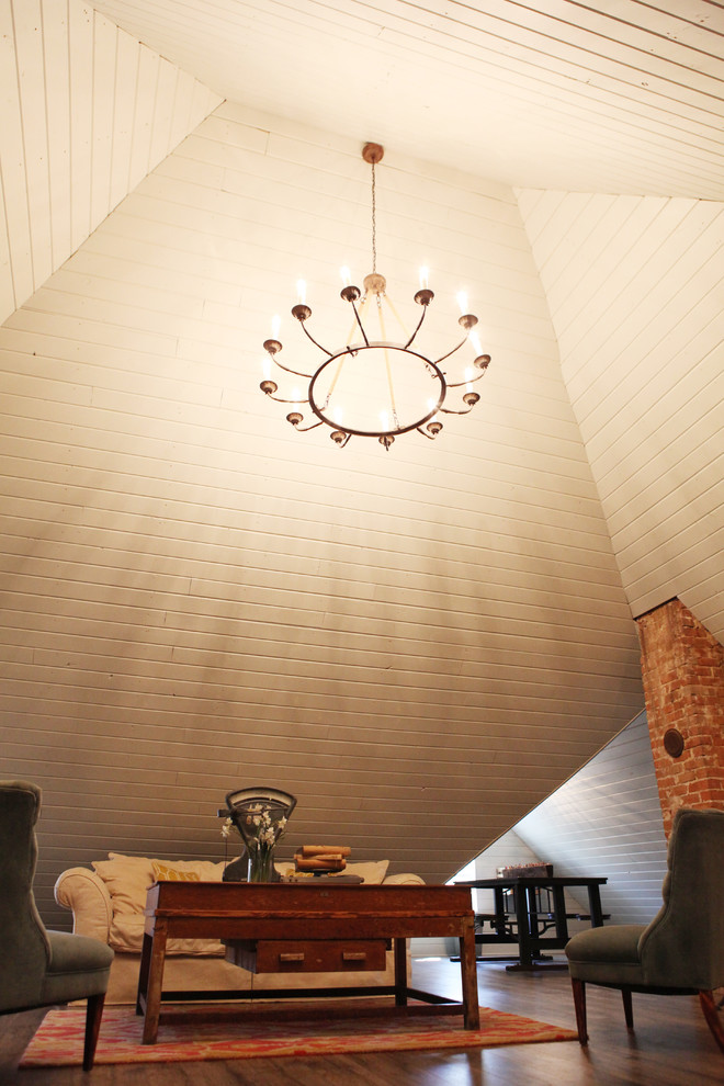 Mid-sized farmhouse loft-style medium tone wood floor family room photo in Austin with white walls