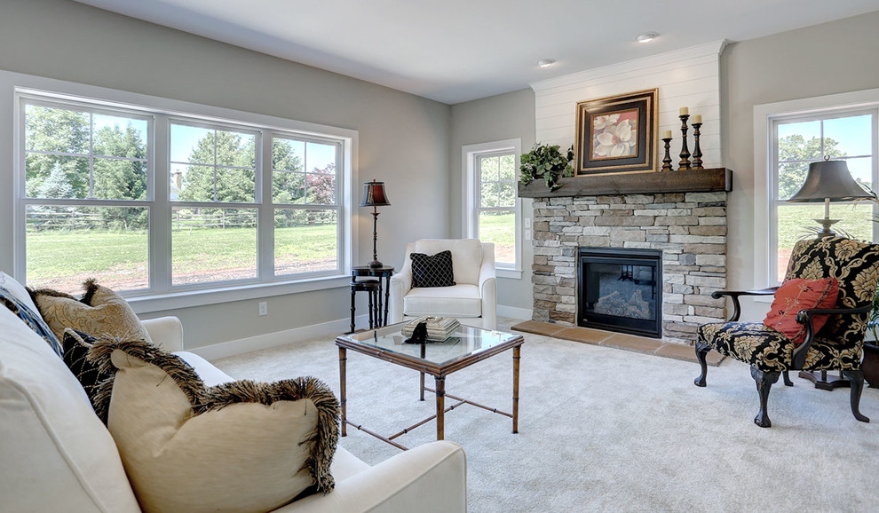 Example of a mid-sized farmhouse enclosed carpeted and beige floor family room design in Other with beige walls, a standard fireplace and a stone fireplace