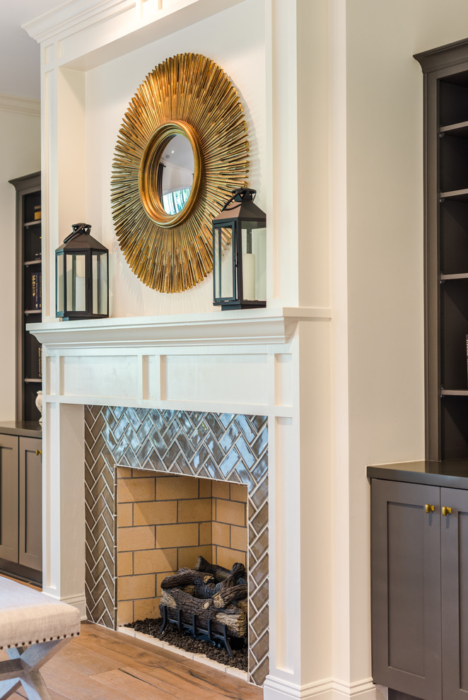 Inspiration for a classic games room in Jacksonville with white walls, medium hardwood flooring, a standard fireplace and a tiled fireplace surround.
