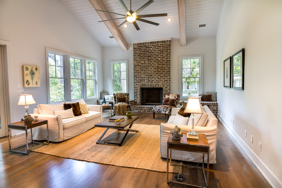 Inspiration for a medium sized classic games room in Charleston with beige walls, dark hardwood flooring, a standard fireplace and a brick fireplace surround.