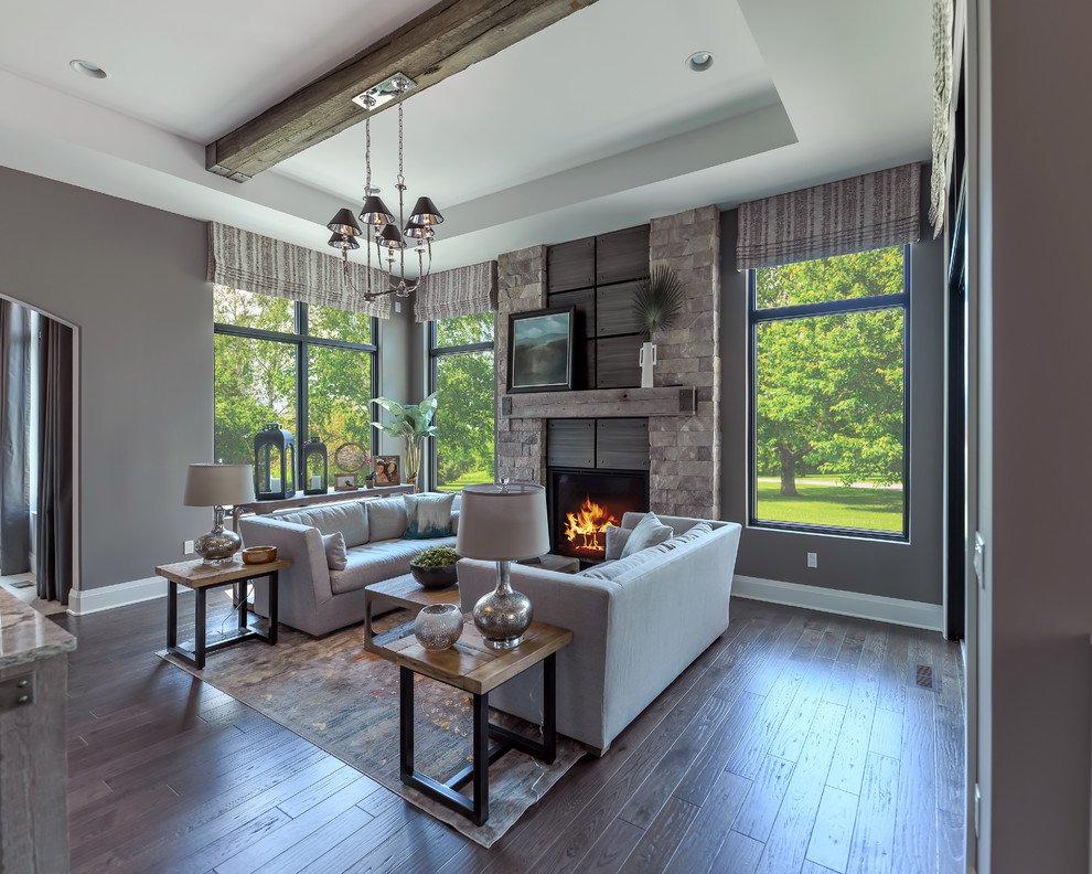 Example of a mid-sized transitional open concept dark wood floor and gray floor family room design in Detroit with gray walls, a standard fireplace and a stone fireplace