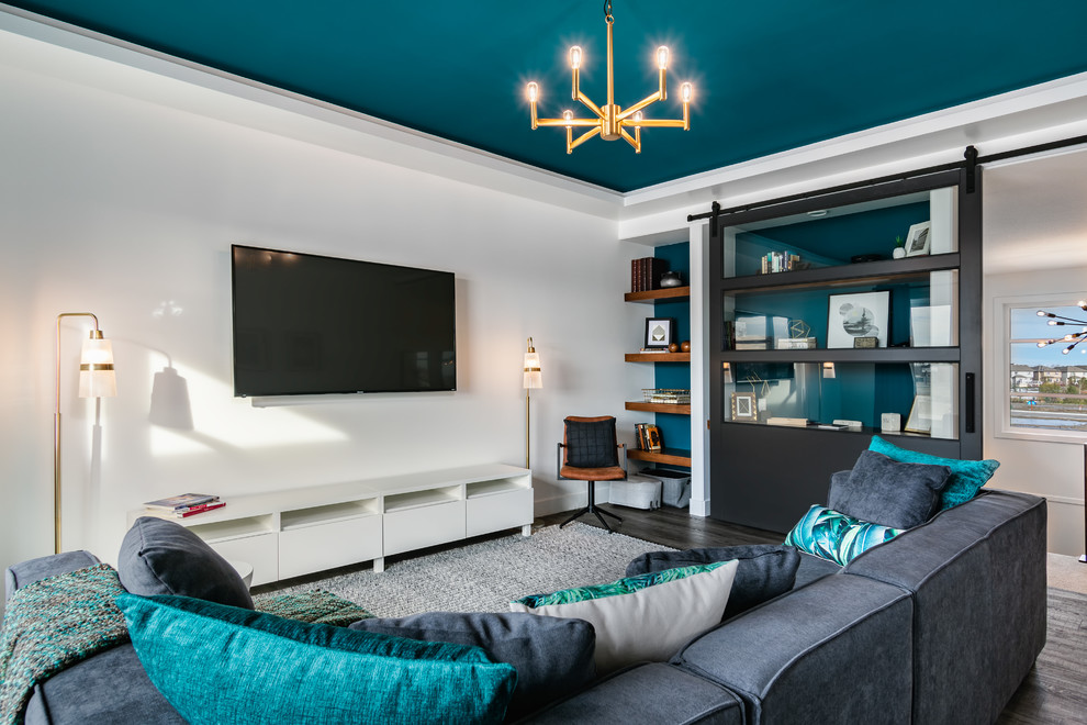 Foto de sala de estar cerrada contemporánea de tamaño medio sin chimenea con paredes blancas, suelo vinílico, televisor colgado en la pared y suelo gris
