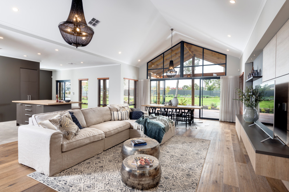 Design ideas for an expansive rural open plan games room in Perth with white walls, medium hardwood flooring, a two-sided fireplace, a tiled fireplace surround and a freestanding tv.