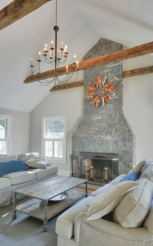 Family room - mid-sized farmhouse enclosed medium tone wood floor family room idea in New York with beige walls, a standard fireplace, a stone fireplace and a media wall