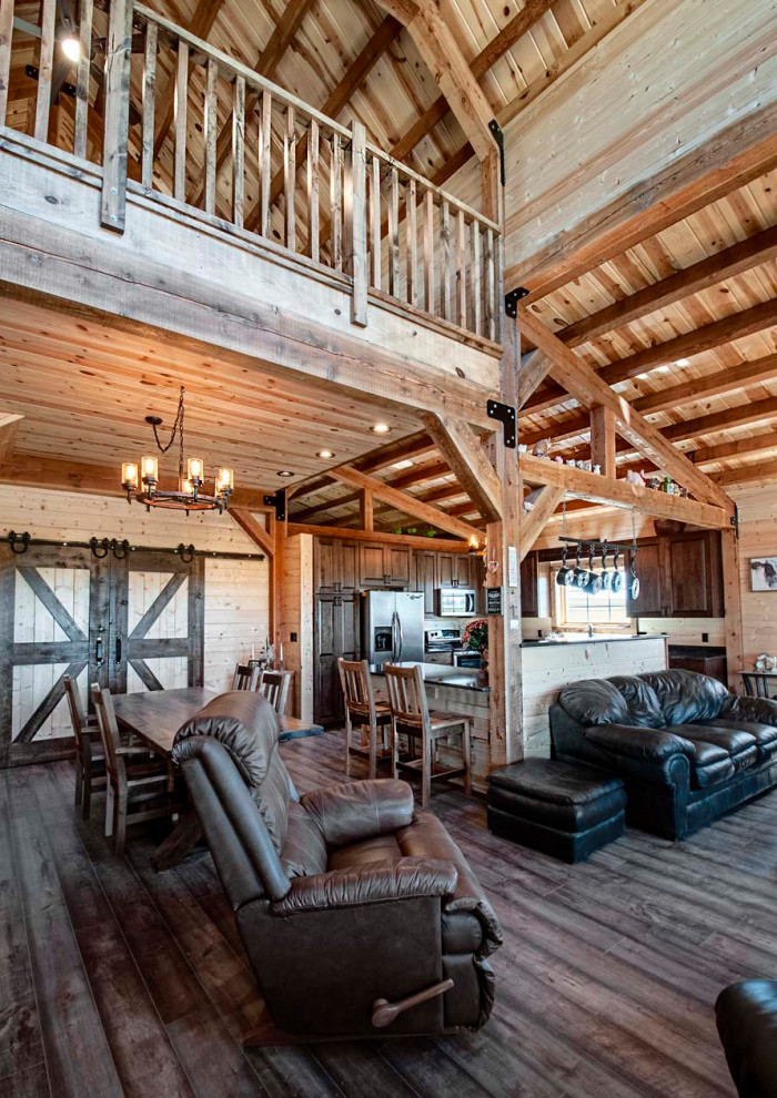 Large mountain style open concept medium tone wood floor, exposed beam and shiplap wall family room photo
