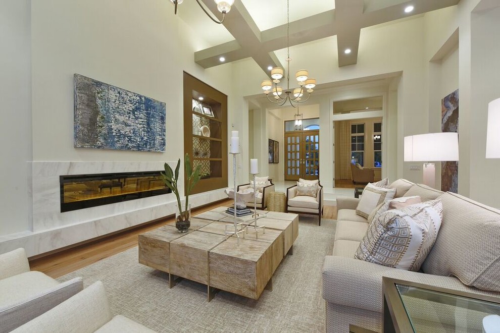 This is an example of a large contemporary open plan games room in Tampa with beige walls, medium hardwood flooring, a ribbon fireplace, a stone fireplace surround and brown floors.