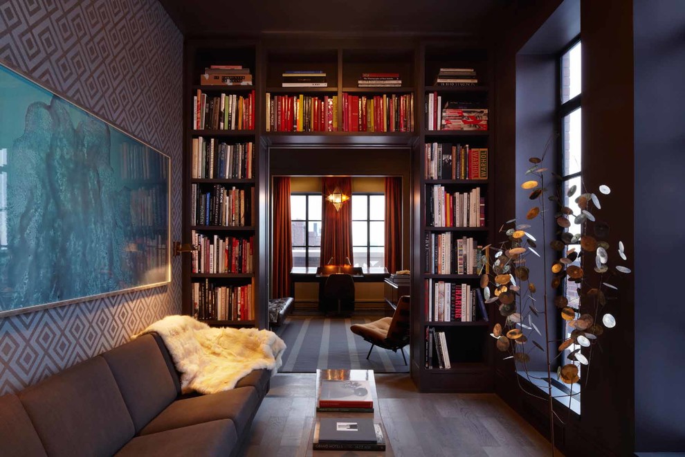Inspiration for a mid-sized transitional medium tone wood floor family room library remodel in New York with black walls and no fireplace