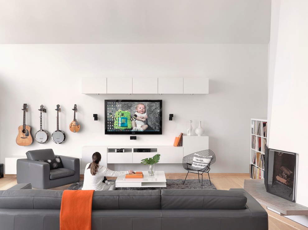 Danish open concept light wood floor family room photo in St Louis with a music area, white walls, a corner fireplace, a plaster fireplace and a media wall