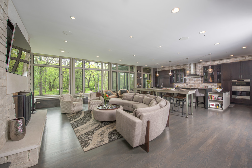 Inspiration for a transitional open concept dark wood floor and brown floor family room remodel in Chicago with multicolored walls, a standard fireplace, a stone fireplace and a media wall