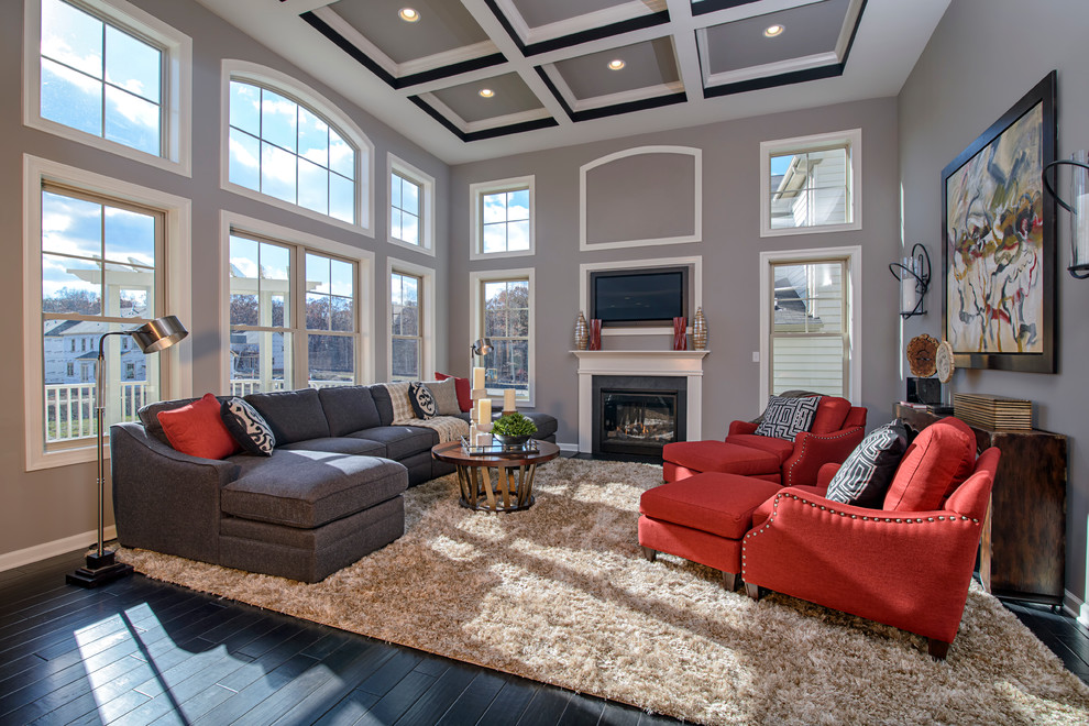 Large traditional open plan games room in DC Metro with a reading nook, grey walls, dark hardwood flooring, a standard fireplace and a wall mounted tv.