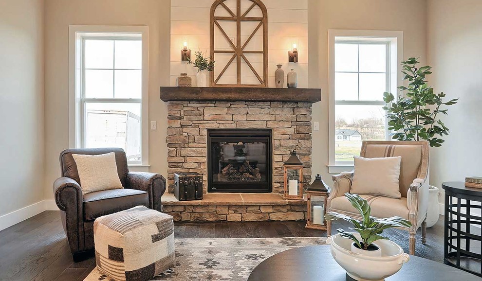 Large rustic enclosed living room in Other with grey walls, dark hardwood flooring, a standard fireplace and a stone fireplace surround.
