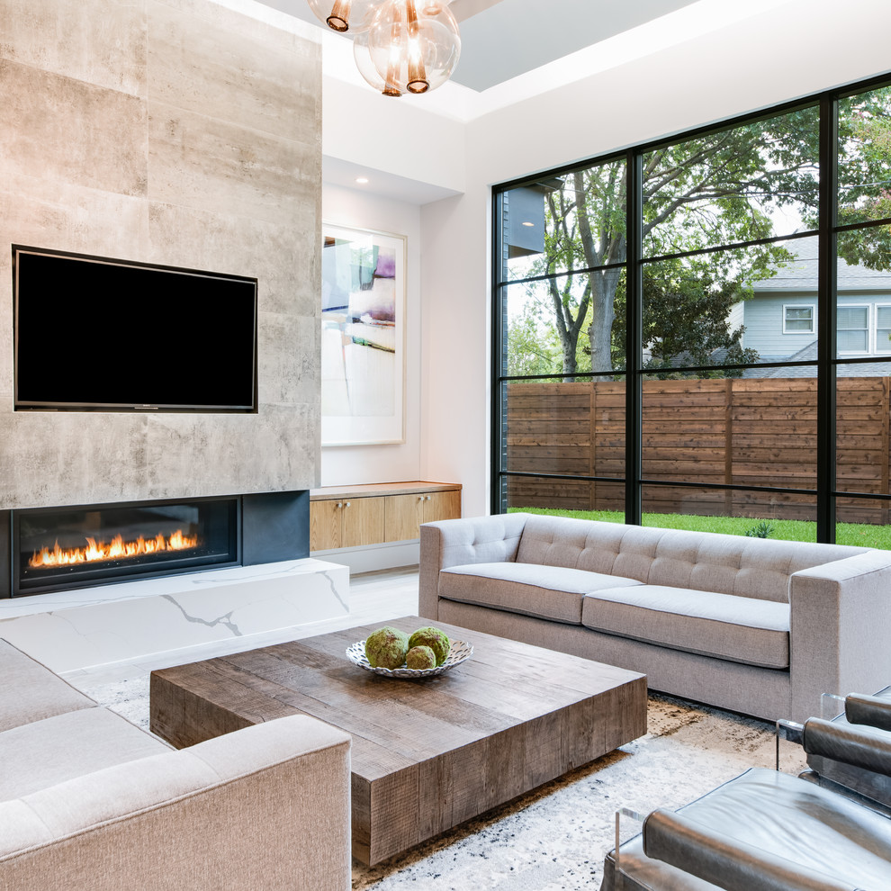 Mid-sized trendy open concept light wood floor and gray floor family room photo in Dallas with white walls, a ribbon fireplace, a tile fireplace and a media wall