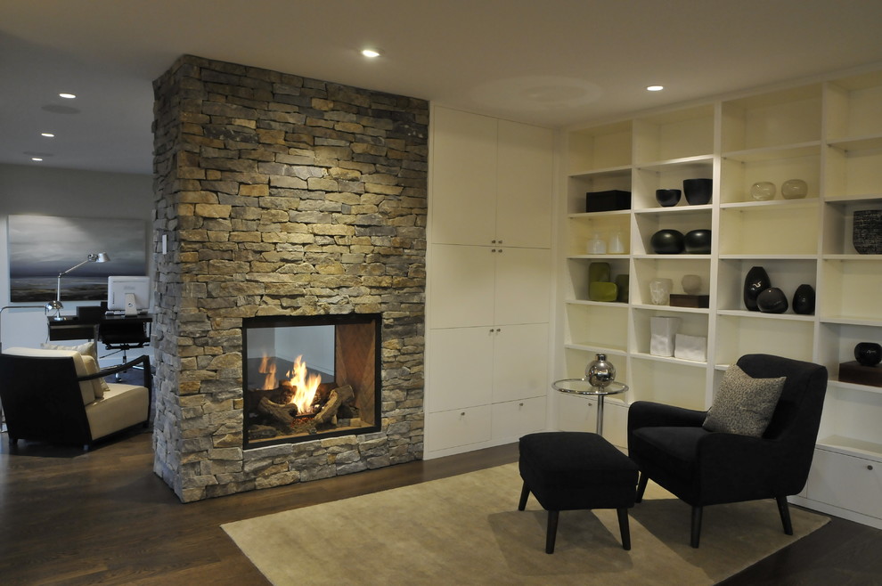 Family room - mid-sized modern open concept dark wood floor and brown floor family room idea in Vancouver with white walls, a two-sided fireplace and a stone fireplace