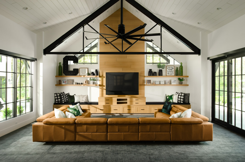 Imagen de sala de estar de estilo de casa de campo con paredes blancas, moqueta, televisor colgado en la pared, suelo gris y machihembrado