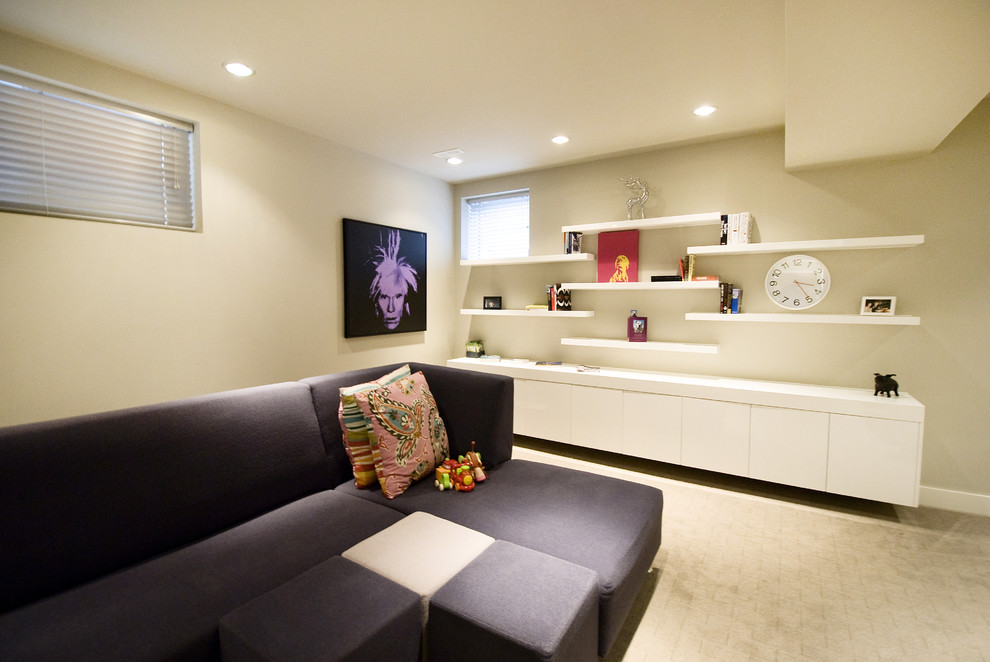 This is an example of a contemporary games room in Calgary with beige walls and carpet.