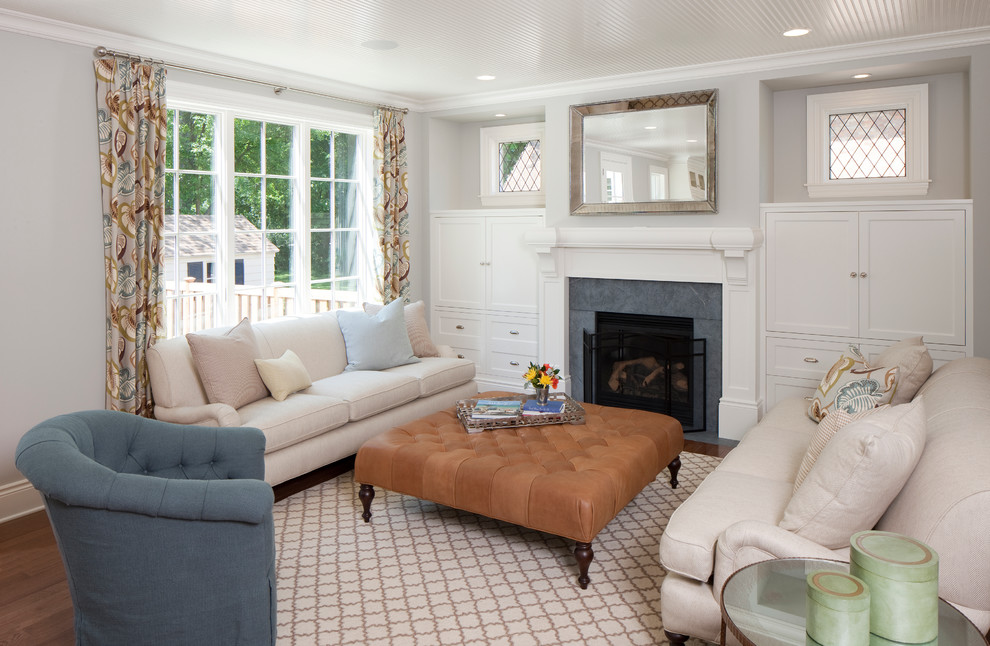 Inspiration for a timeless family room remodel in Grand Rapids with gray walls, a standard fireplace and a stone fireplace